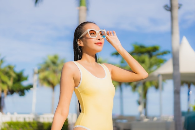 Portrait beautiful young asian woman relaxing outdoor in swimming pool in holiday trip