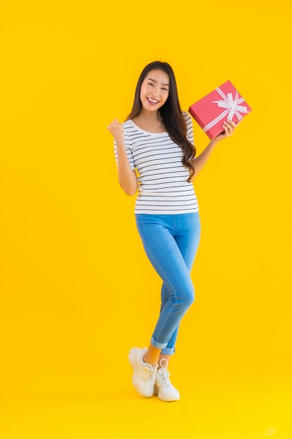 Portrait beautiful young asian woman show red gift box