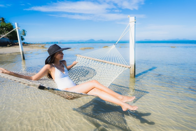 Portrait beautiful young asian woman sitting on hammock around sea beach ocean for relax