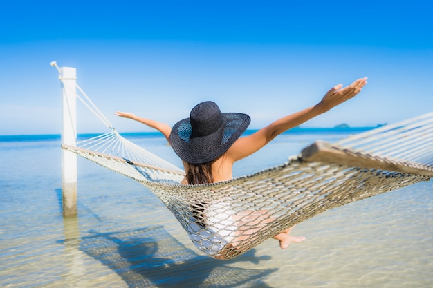 Portrait beautiful young asian woman sitting on hammock around sea beach ocean for relax