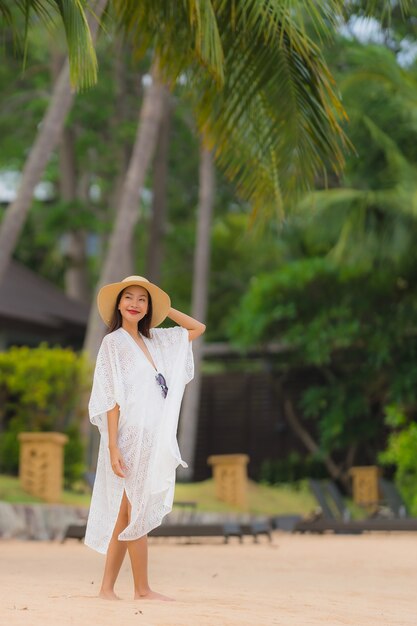 Portrait beautiful young asian woman smile happy relax on the beach sea ocean