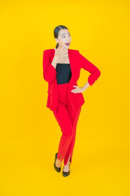 Portrait beautiful young asian woman smile with action on yellow