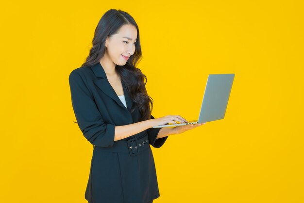 Portrait beautiful young asian woman smile with computer laptop on isolated background