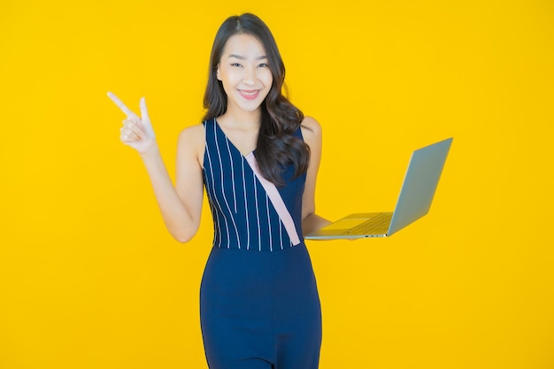 Portrait beautiful young asian woman smile with computer laptop on isolated background