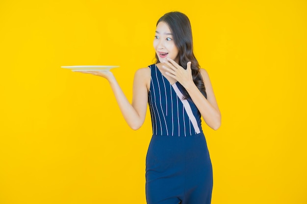 Portrait beautiful young asian woman smile with empty plate dish on