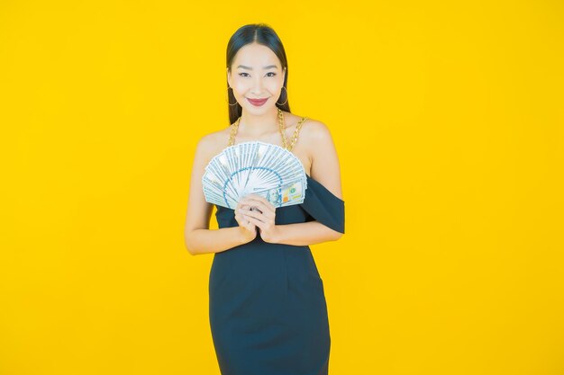 Portrait of beautiful  young asian woman smile with a lot of cash and money