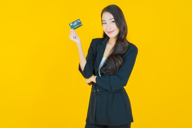 Portrait beautiful young asian woman smile with smart mobile phone on yellow