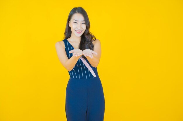 Portrait beautiful young asian woman smile on yellow