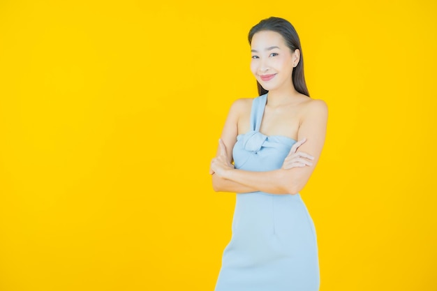 Portrait beautiful young asian woman smile on yellow