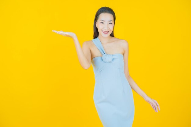 Portrait beautiful young asian woman smile on yellow