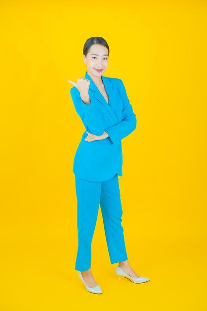 Portrait beautiful young asian woman smile on yellow