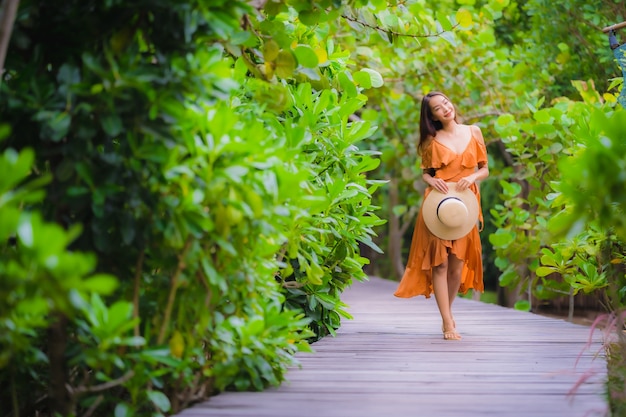 Portrait beautiful young asian woman walk on path walk in the garden