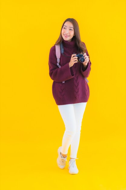 Portrait beautiful young asian woman with backpack and camera for travel in vacation