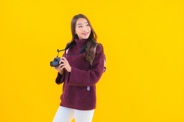 Portrait beautiful young asian woman with backpack and camera for travel in vacation