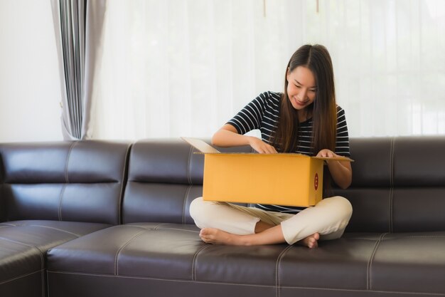 Portrait of beautiful young asian woman with cardboard parcel box