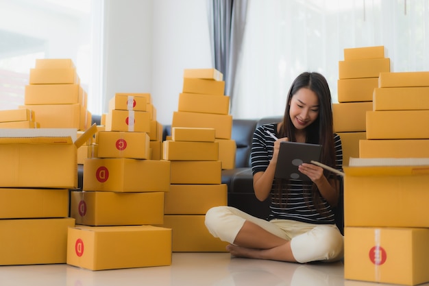 Portrait of beautiful young asian woman with cardboard parcel boxes