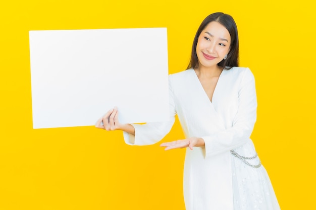 Portrait beautiful young asian woman with empty white billboard