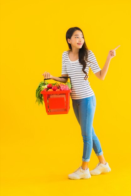 Portrait beautiful young asian woman with grocery basket cart from supermarket in shopping mall