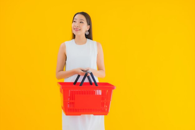 Portrait beautiful young asian woman with grocery basket for shopping from supermarket