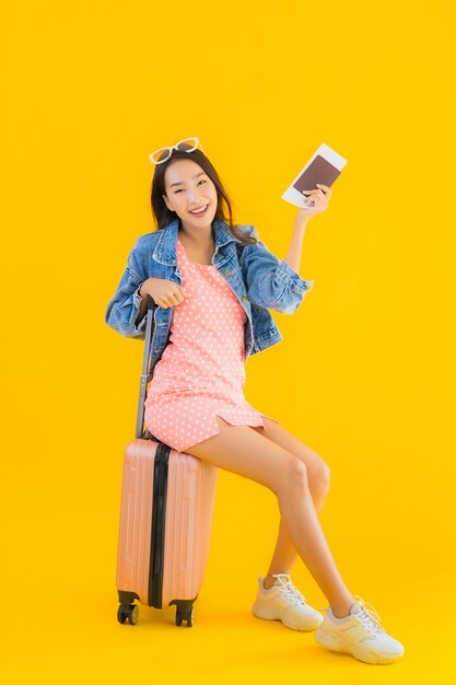 Portrait beautiful young asian woman with luggage travel bag with passport and boarding pass ticket