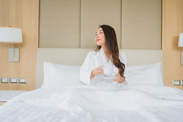 Portrait beautiful young asian woman with smart mobile phone in bedroom