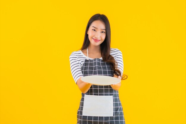 Portrait beautiful young asian woman with white dish or plate