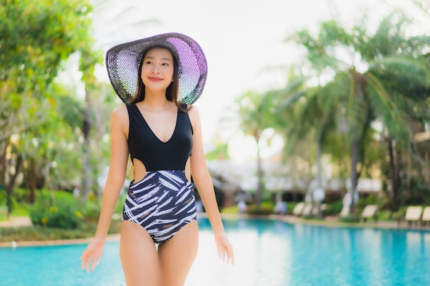 Free photo portrait beautiful young asian women happy smile relax around swimming pool