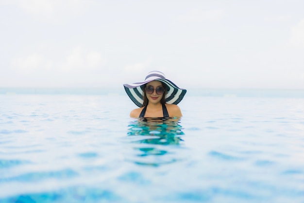 Free Photo portrait beautiful young asian women happy smile relax outdoor swimming pool in resort