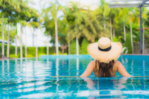 Portrait beautiful young asian women happy smile relax outdoor swimming pool in resort