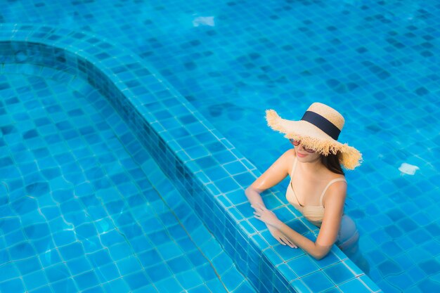 Portrait beautiful young asian women happy smile relax outdoor swimming pool in resort