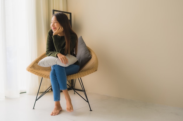 Portrait beautiful young asian women happy smile relax sitting on sofa chair