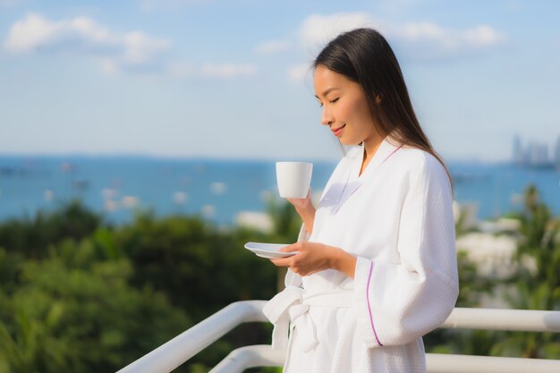 Portrait beautiful young asian women hold coffee cup in hand around outdoor view