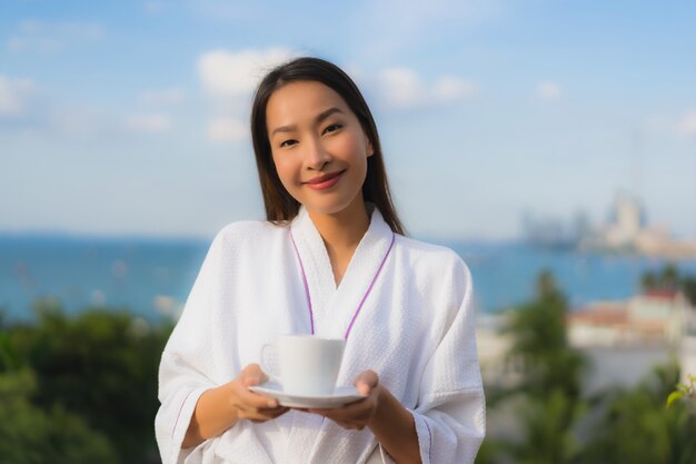 Portrait beautiful young asian women hold coffee cup in hand around outdoor view