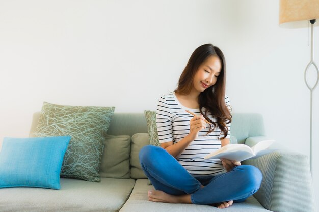 Portrait beautiful young asian women reading book with coffee cup