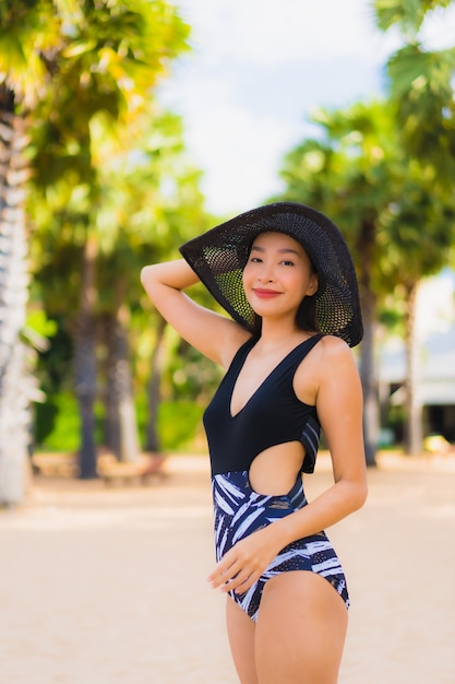 Free photo portrait beautiful young asian women relax smile happy around sea beach ocean