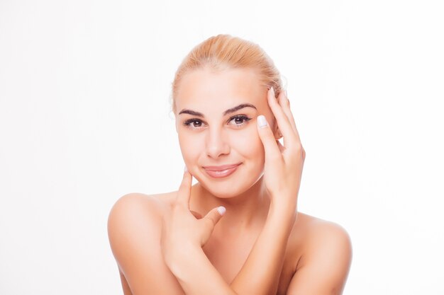 Portrait of beautiful young blond woman with clean face. High key shot.