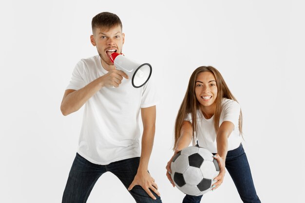 Portrait of beautiful young couple football or soccer fans on white studio