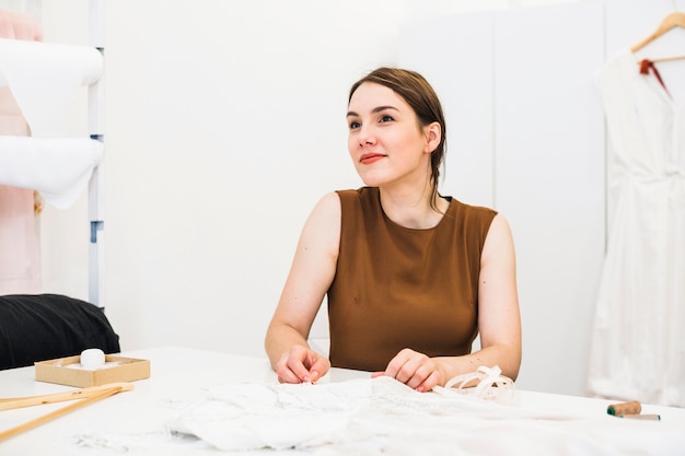 Portrait of a beautiful young fashion designer in studio