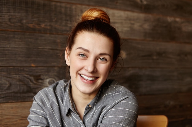 Portrait of beautiful young redhead Caucasian woman smiling cheerfully