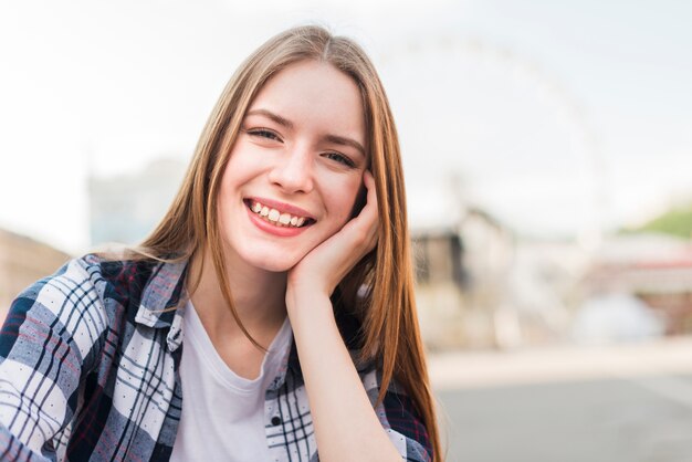 Portrait of beautiful young smiling woman looking at camera