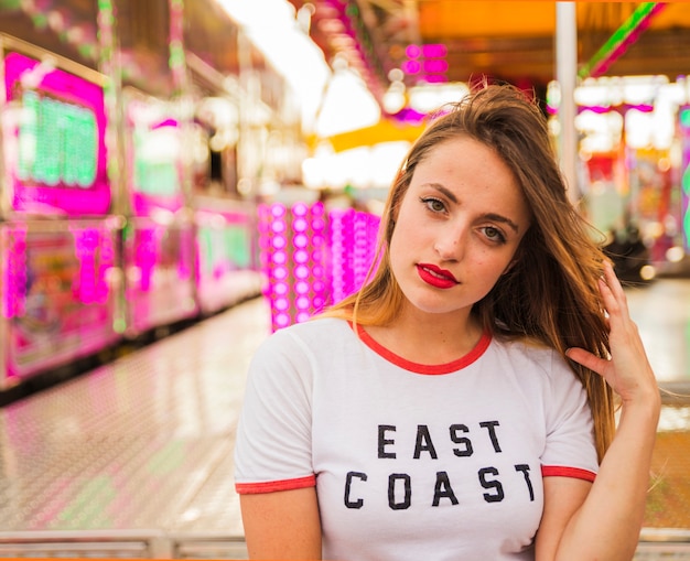 Free Photo portrait of a beautiful young woman at amusement park