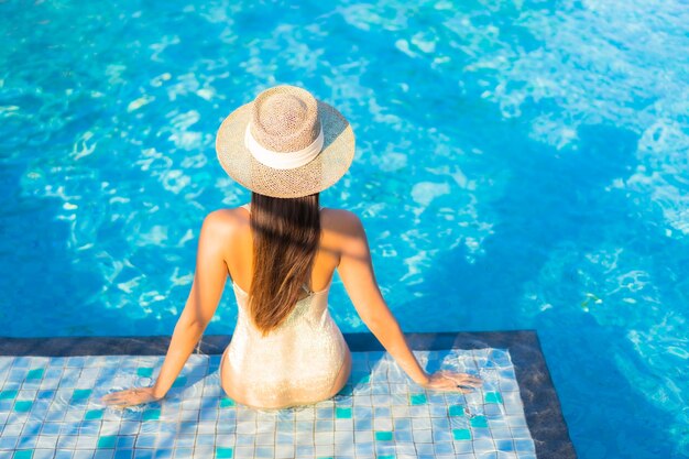 Portrait of beautiful young woman relaxing at the swimming pool