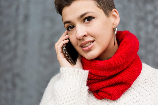 Portrait of beautiful young woman talking on the phone