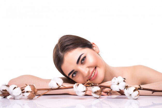 Portrait of beautiful young woman with health skin and with flower on her shoulder isolated