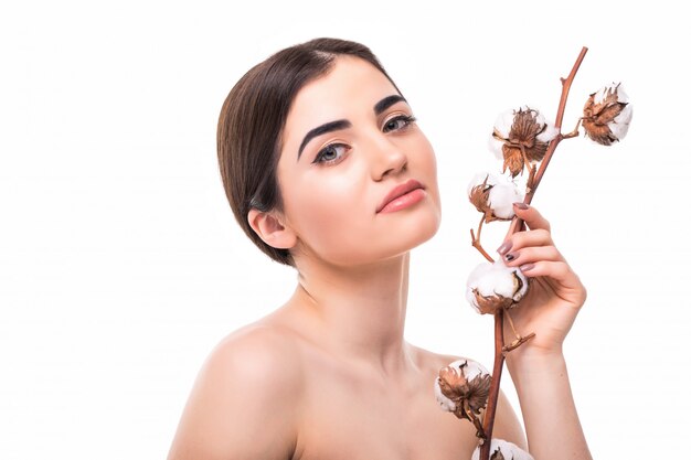 Portrait of beautiful young woman with health skin and with flower on her shoulder isolated