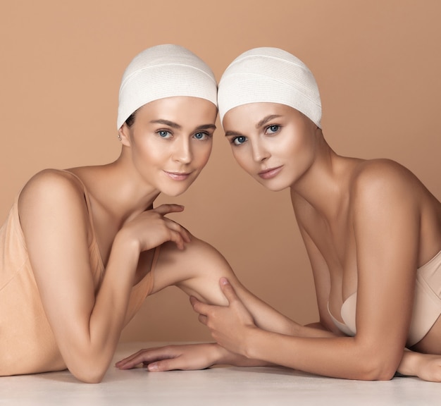 Portrait of beautiful young women on brown studio