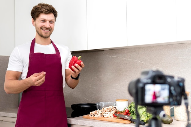 Portrait of blogger recording cooking video at home