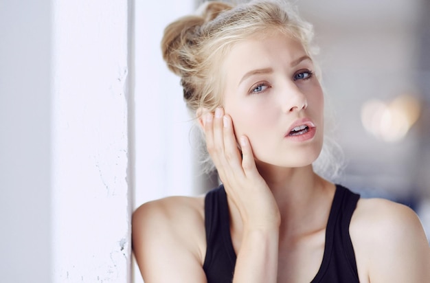 Portrait of blond woman with light make up and blue eyes.