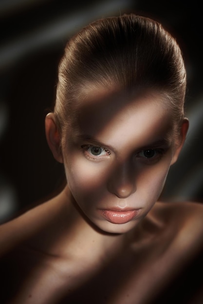 Free Photo portrait of blond woman with shadows and lights on her face.