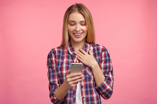 Portrait of blonde woman in striped shirt with phone